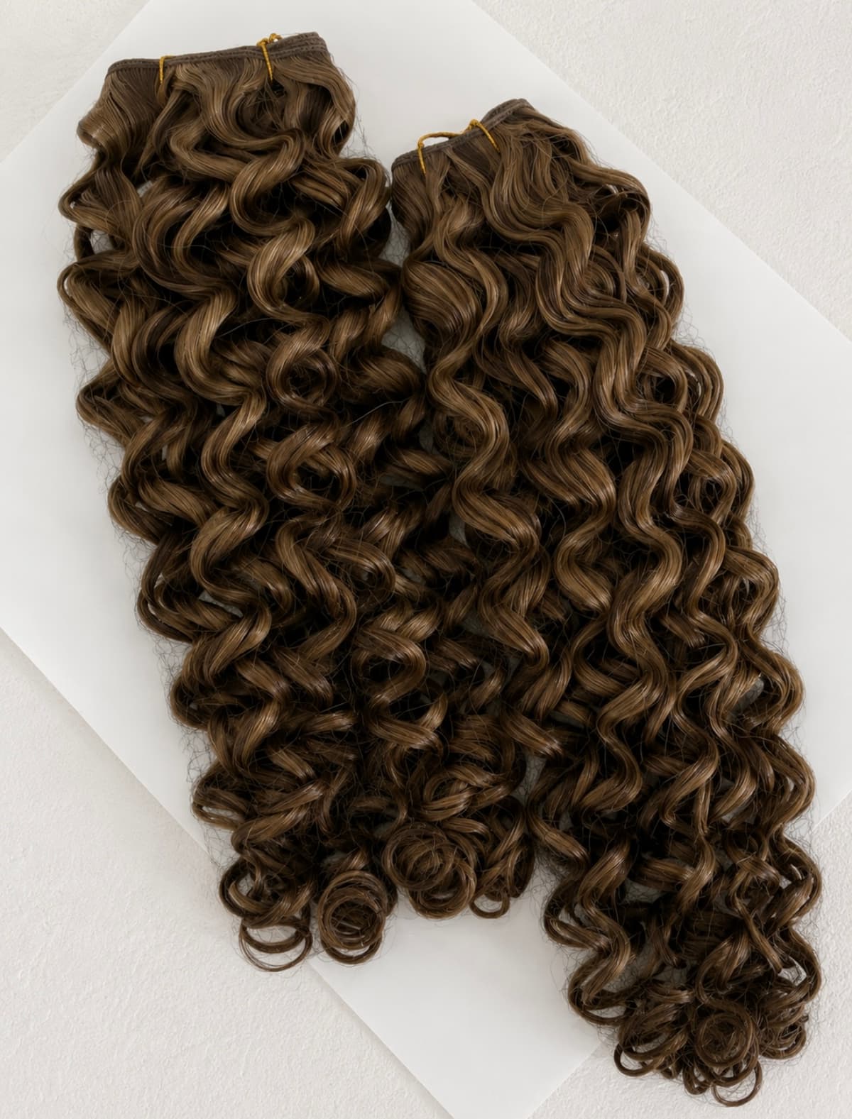 SMJ Hair Curly texture — defined curly extension bundles.